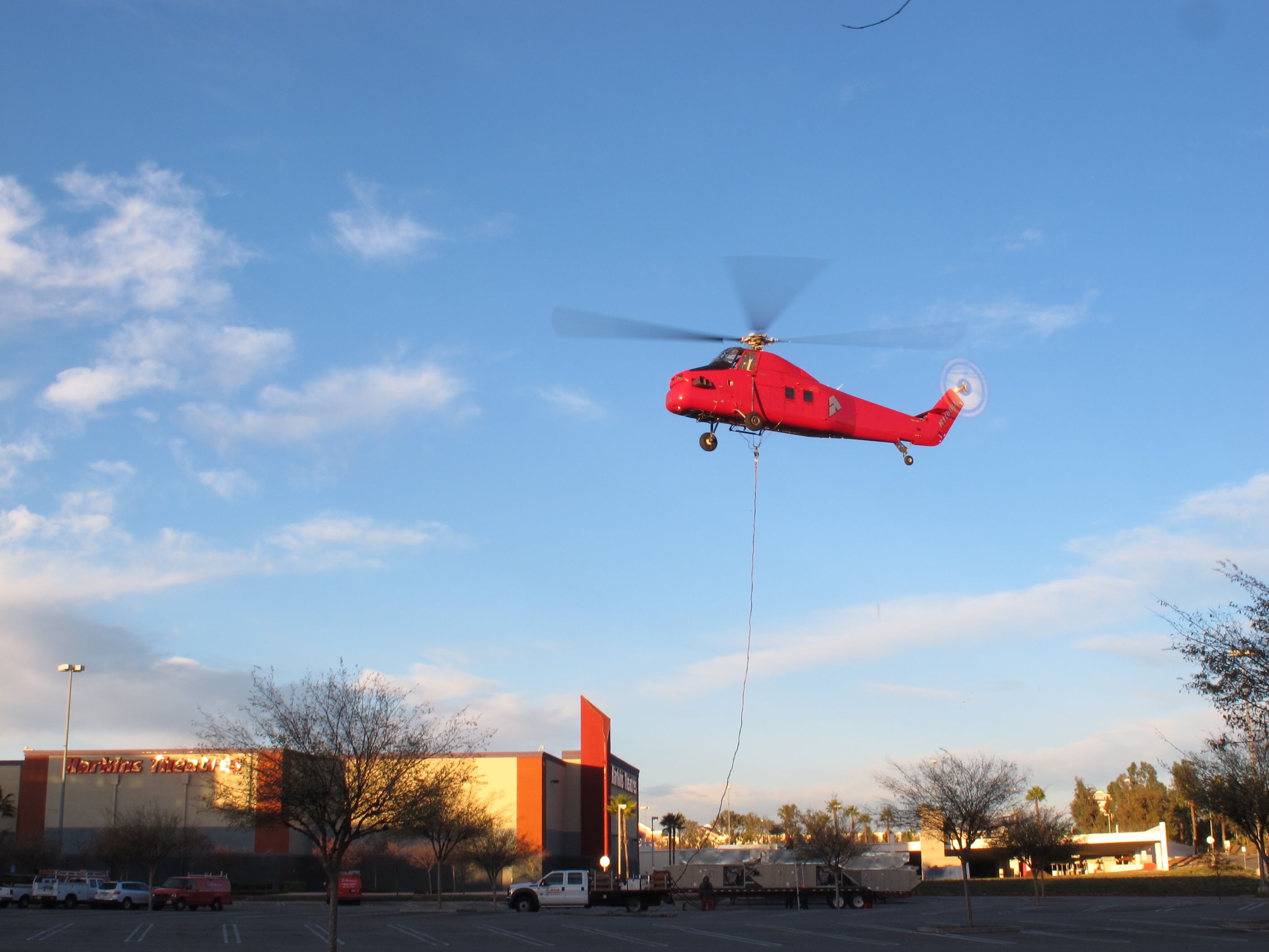 Helicopter lifting an AC unit