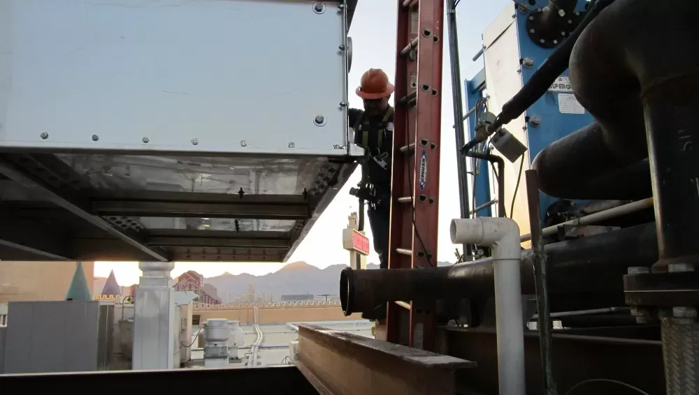Workers installing an ac unit
