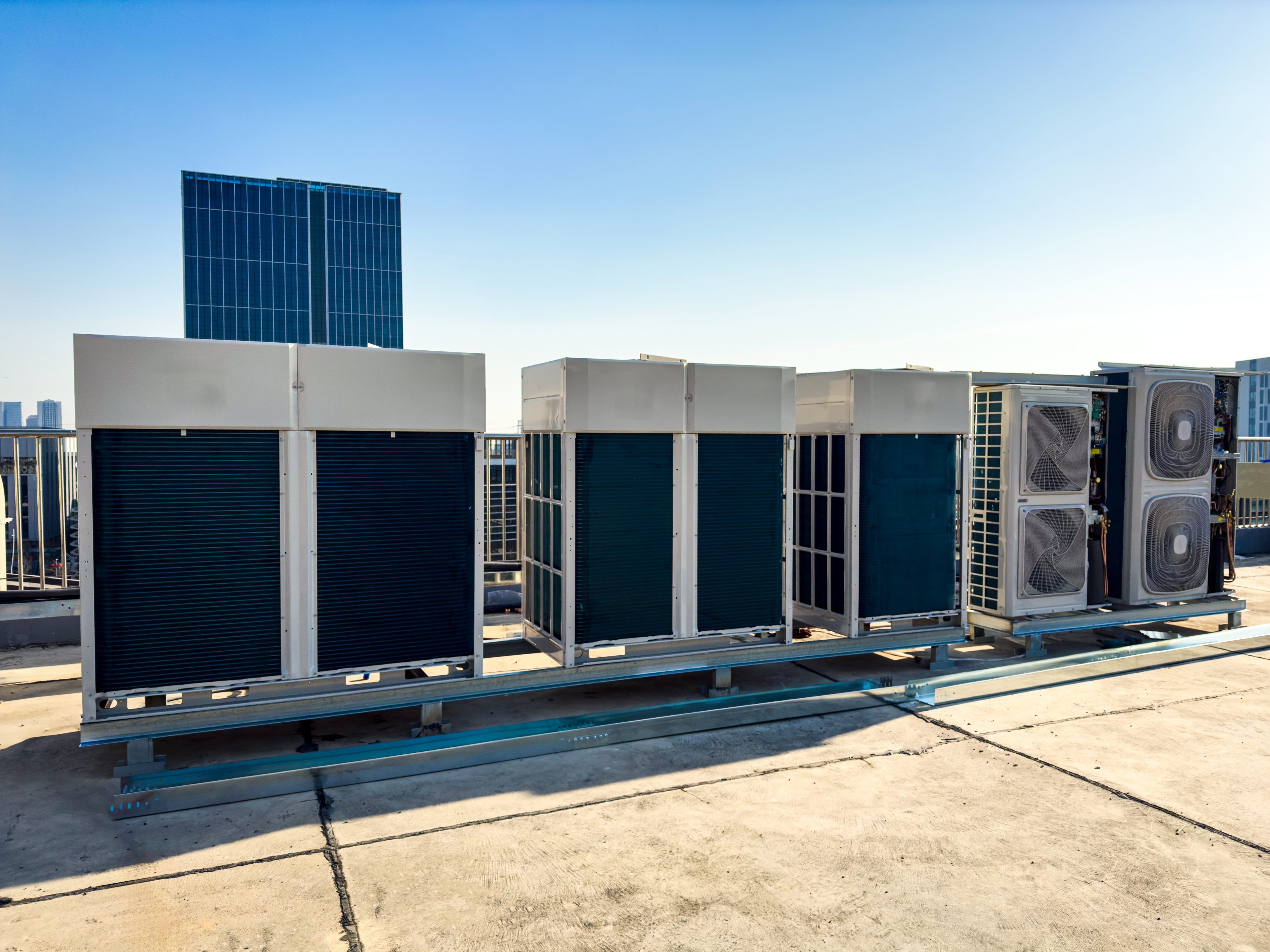 Rooftop Air Conditioning Units with Urban Skyline Background