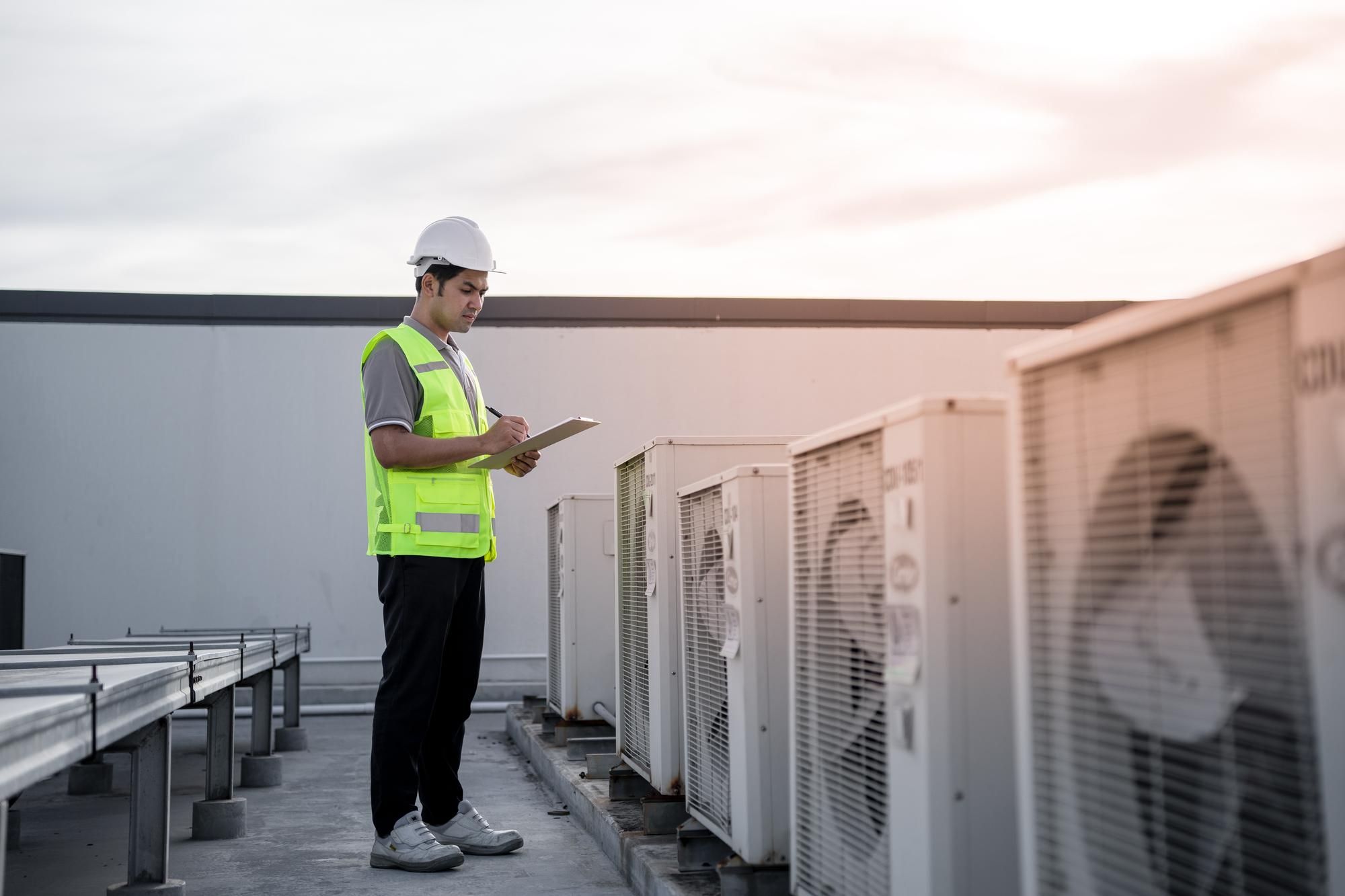 Worker inspecting AC